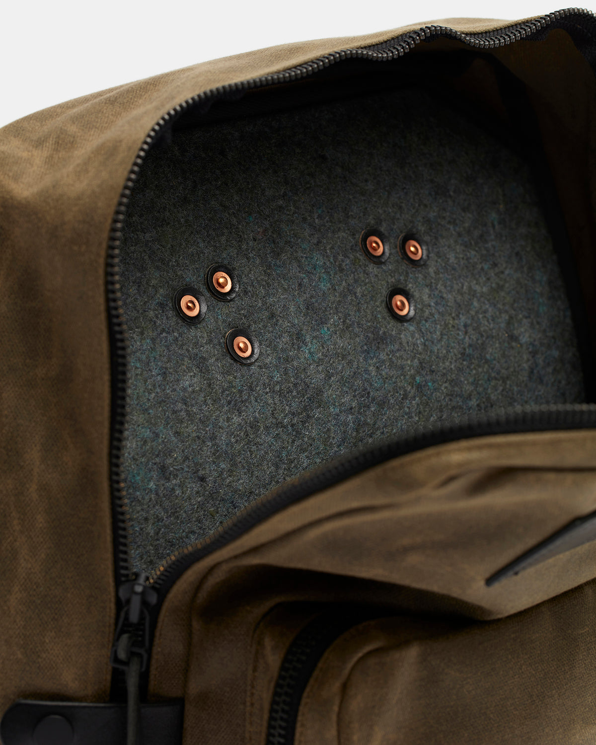 Close-up of solid copper rivets and wool details on Nova backpack