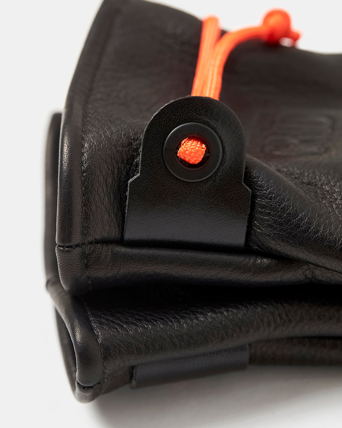 Close-up of orange paracord and locking eyelet on Mitsuhiko mittens