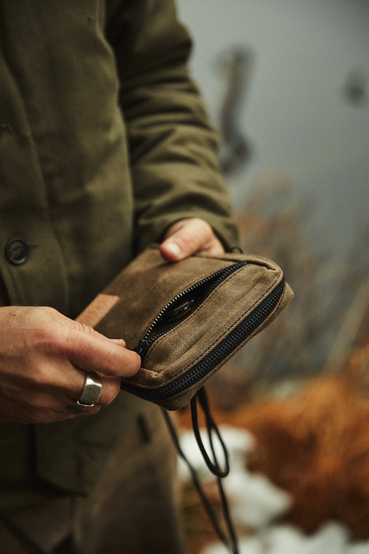 Close-up of hand-finished leather details on Nika waxed canvas bag