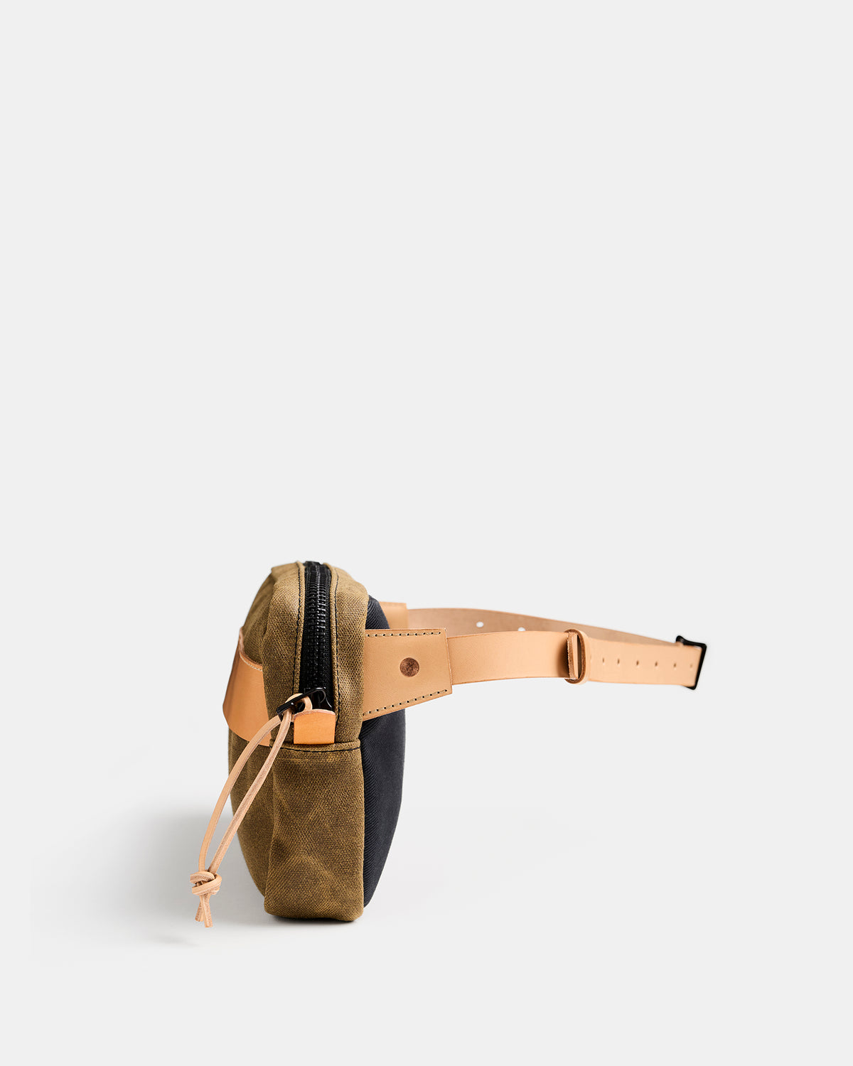 Töfte crossbody bag in natural waxed canvas and Tärnsjö leather from side