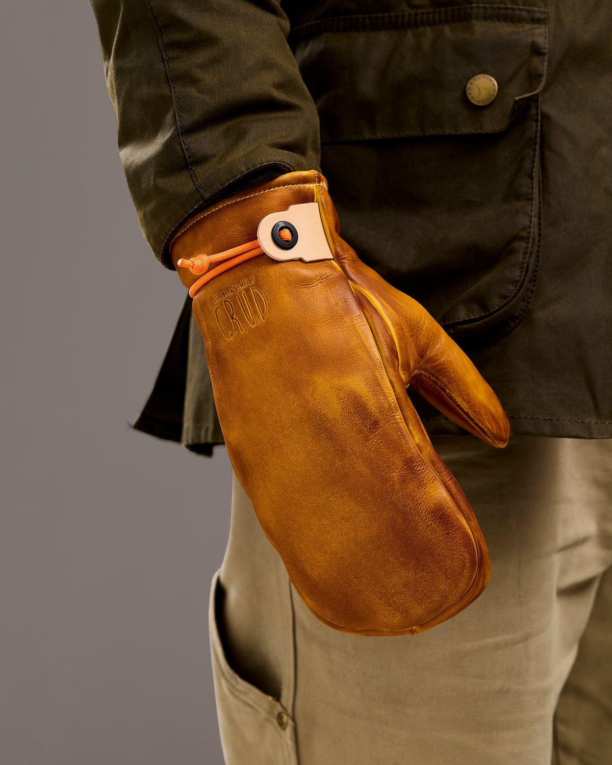 Mitsuhiko yellow mittens shown worn on hand