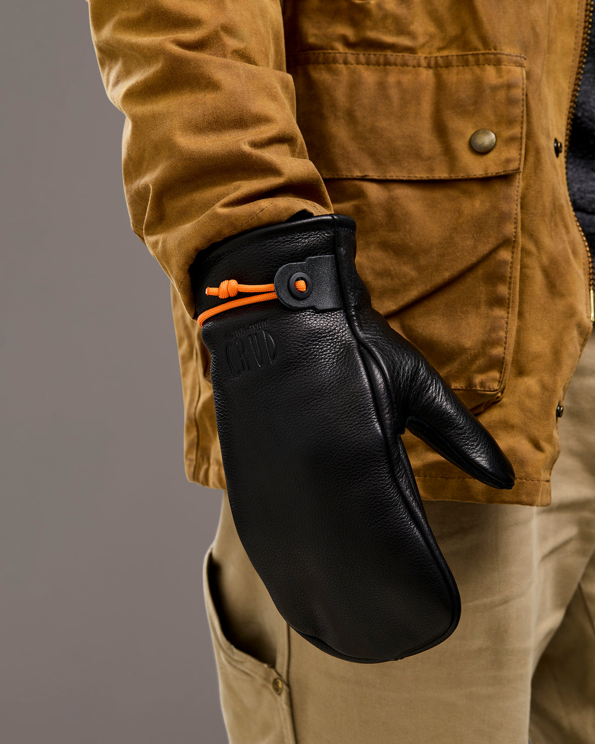 Mitsuhiko black mittens shown worn on hand