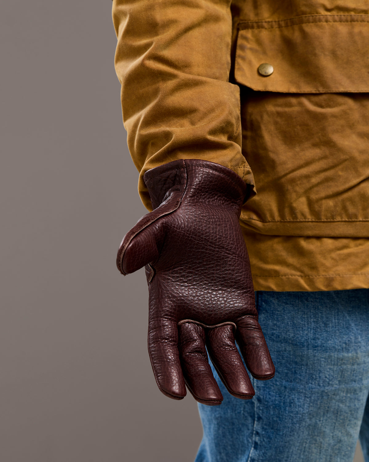 Palm and distinctive grain pattern on mahogany brown bison leather gloves