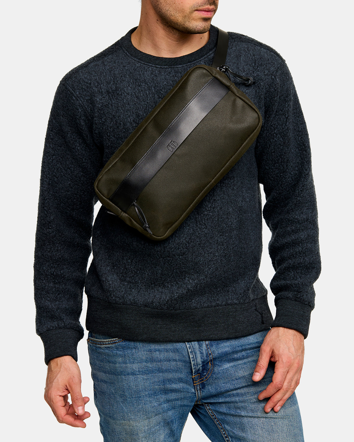 Töfte waxed canvas crossbody black bag worn over the shoulder