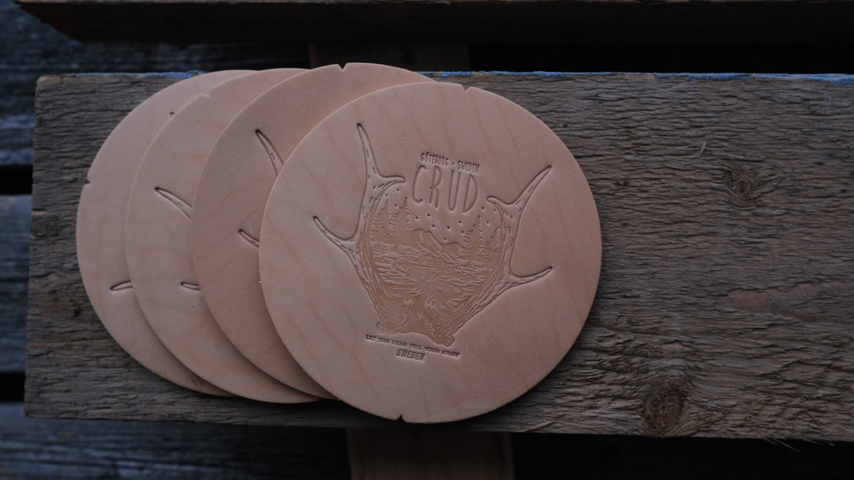 Close-up of natural vegetable-tanned leather on handcrafted coasters