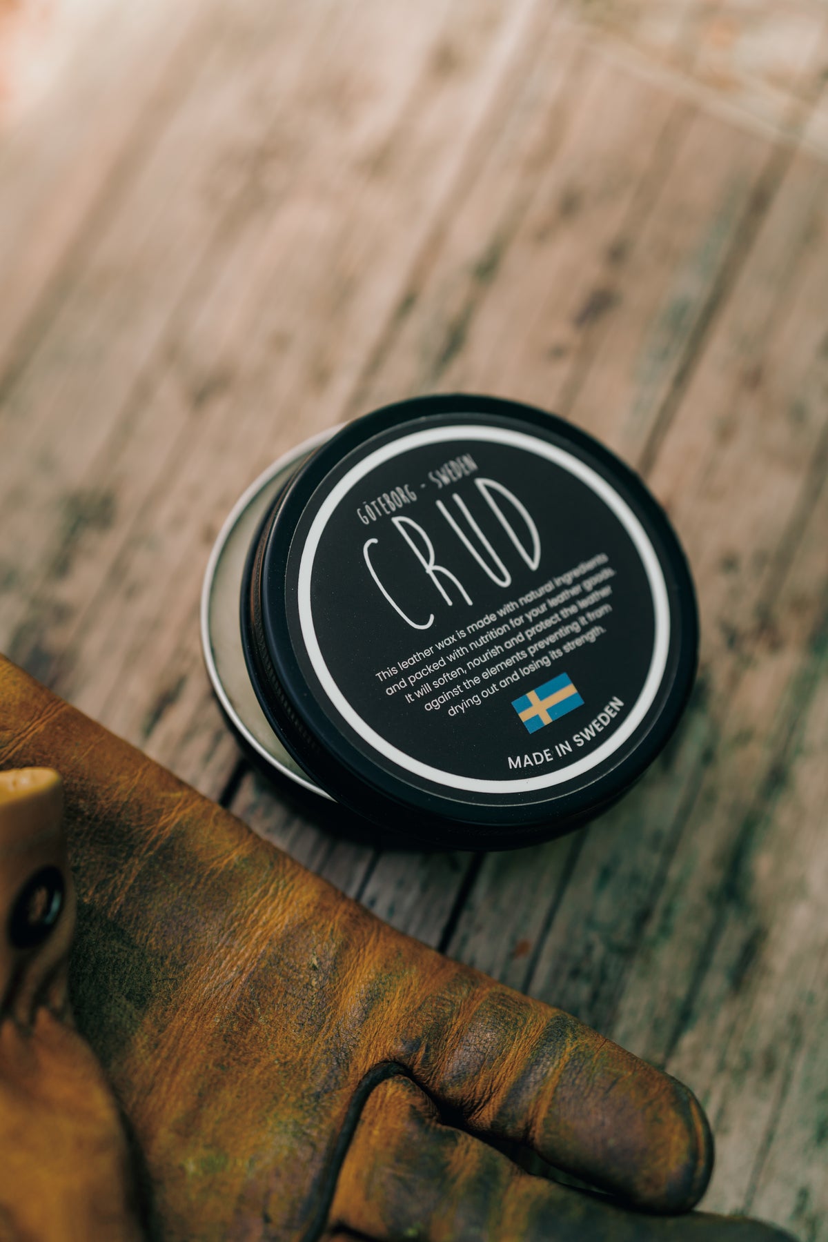 Close-up of Crud leather wax in matte black aluminium container