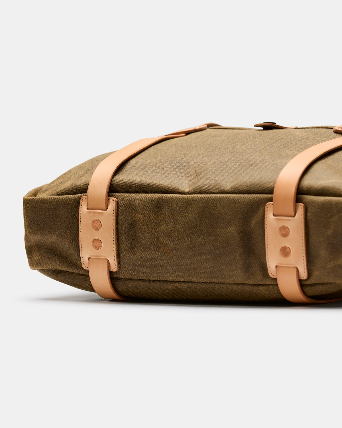 Close-up of solid copper rivets and hand-finished leather on Alta briefcase