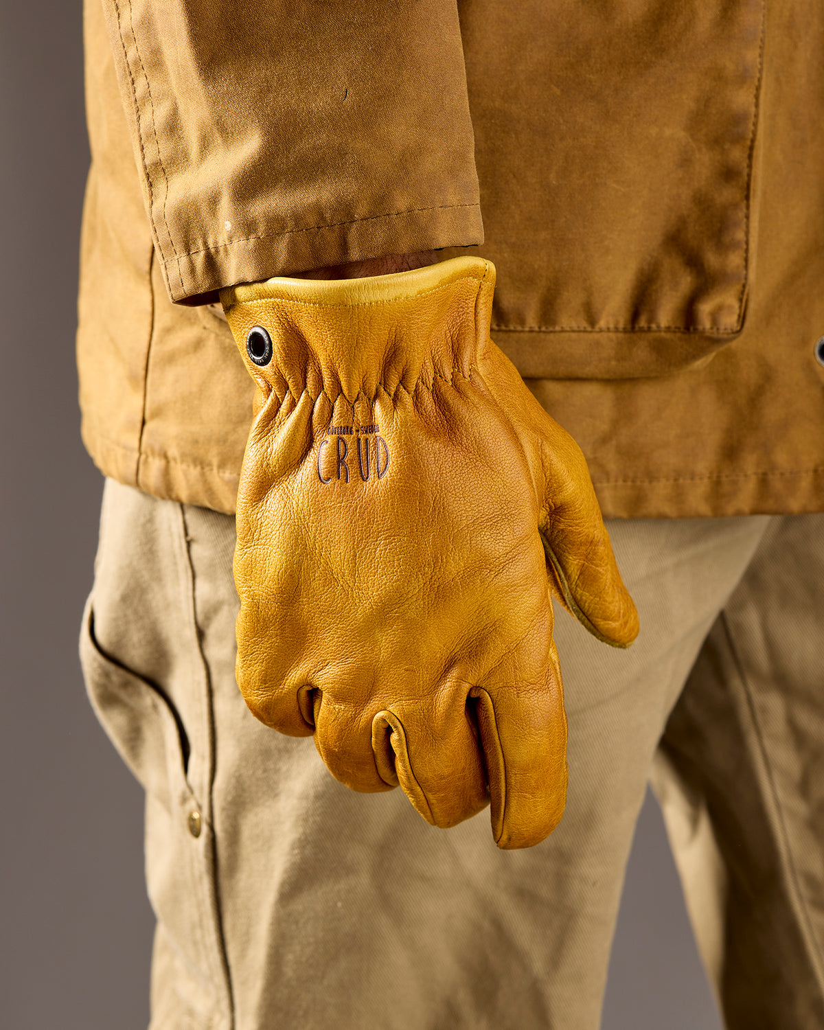 Heavy-duty leather gloves with brass eyelets on model