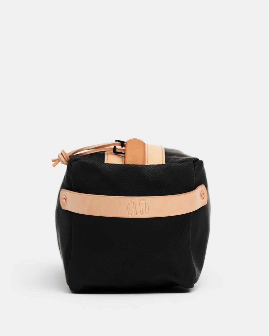 End view of black Crud toiletry bag with leather strap embossed Crud Göteborg Sweden