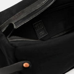 Inside of black toiletry bag with black Crud Made in Sweden label