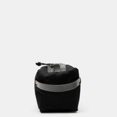 End view of black Crud toiletry bag with embossed black leather strap
