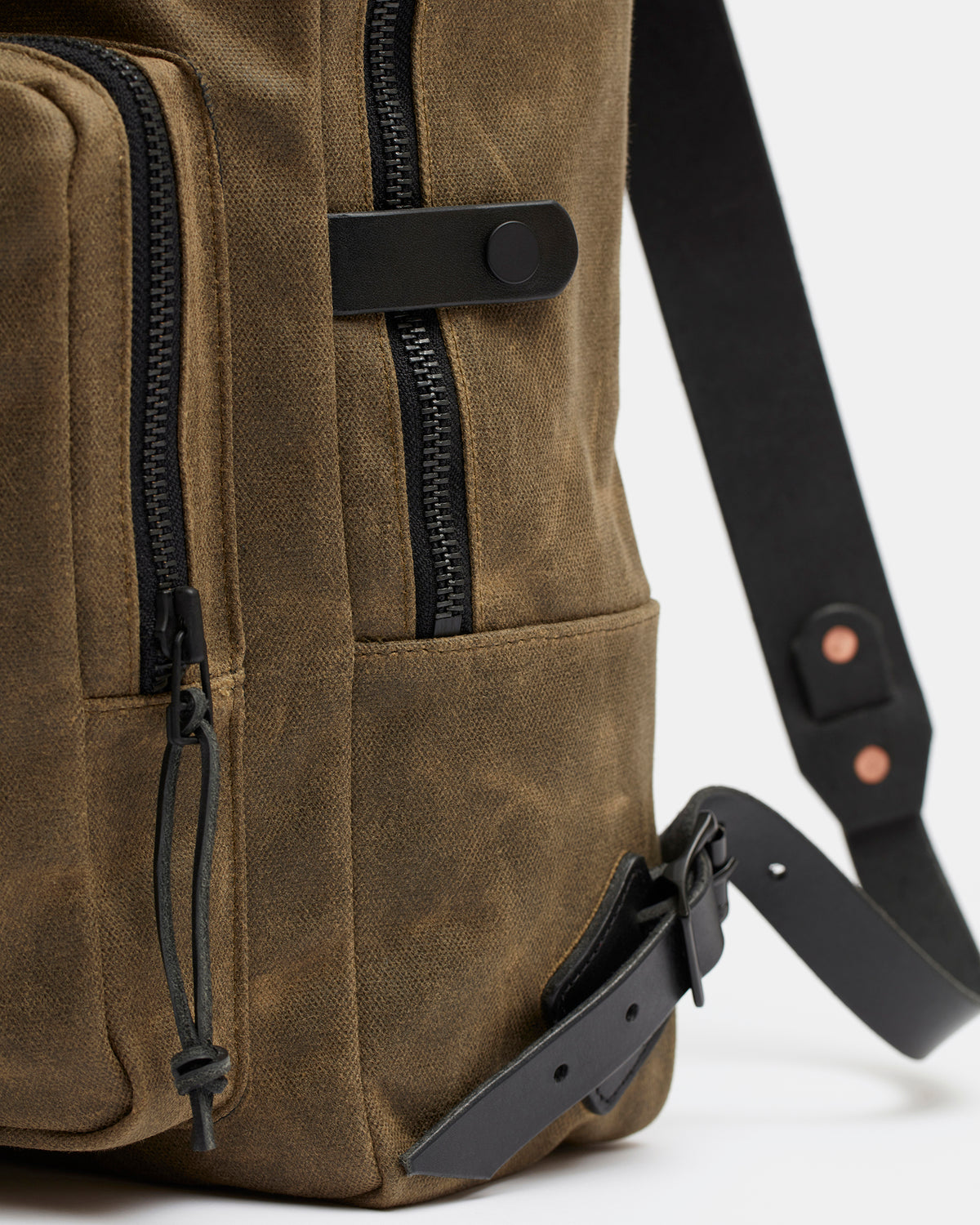 Close-up of hand-finished and waxed leather edges on Nova backpack