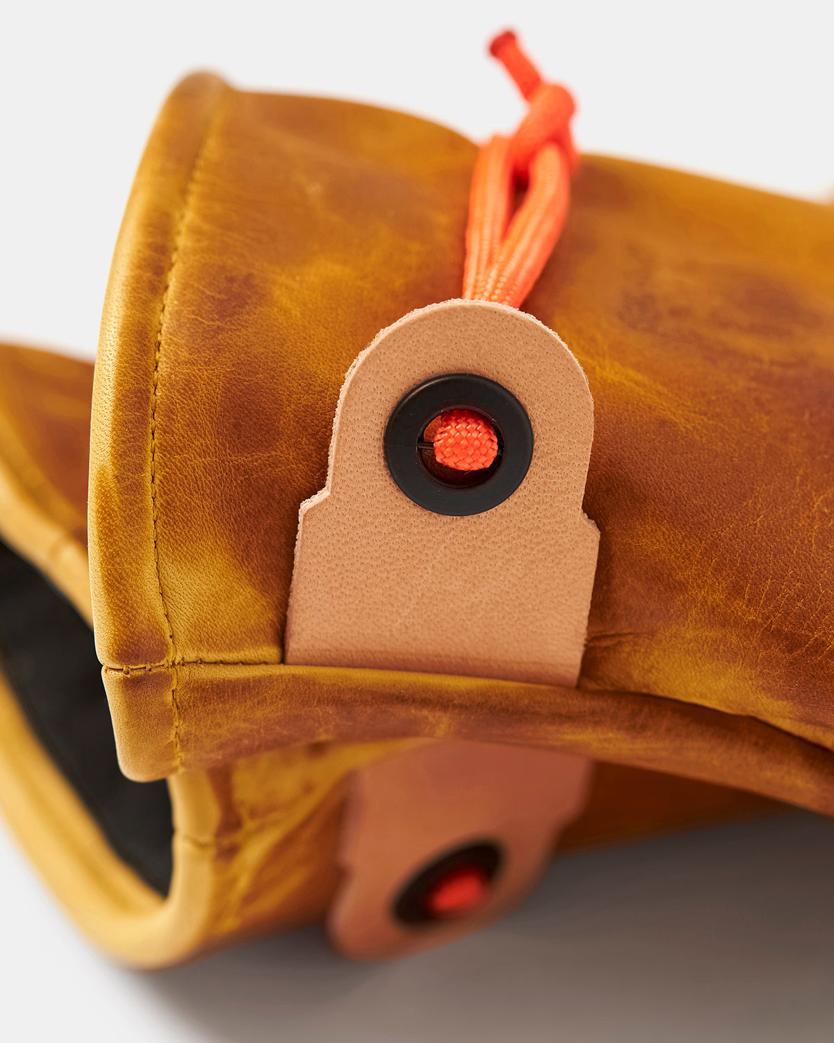 Close-up of orange paracord and locking eyelet on Mitsuhiko mittens